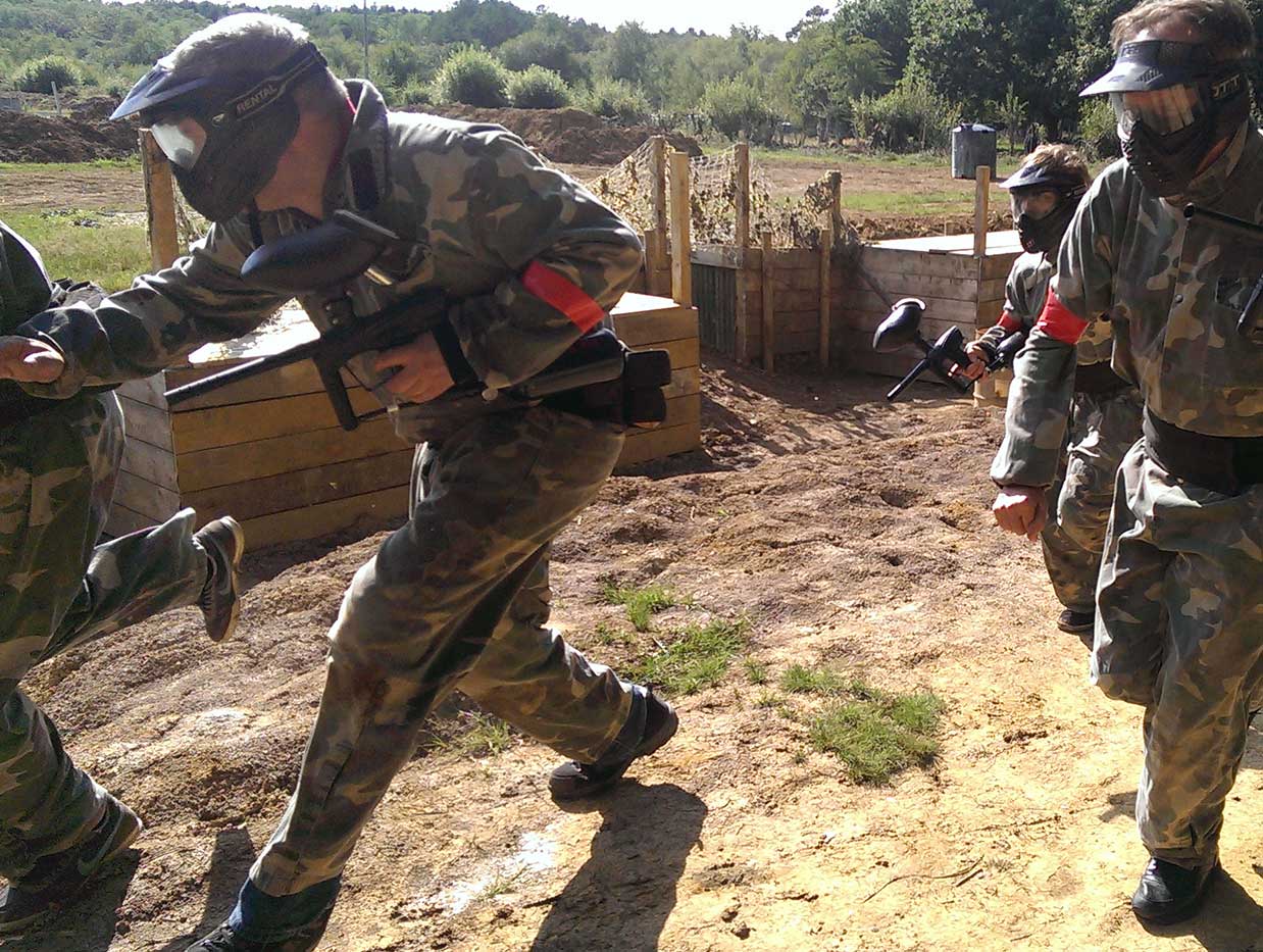 Red team clearing out the oppositions trench system with their paintball guns, during a battle.