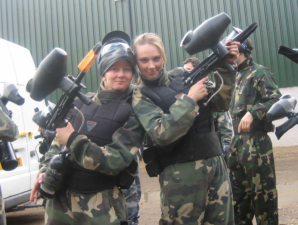 Hen party members dressed in camouflage overalls holding their paintball guns.
