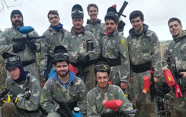 stag party posing for a group photo with their paintball markers