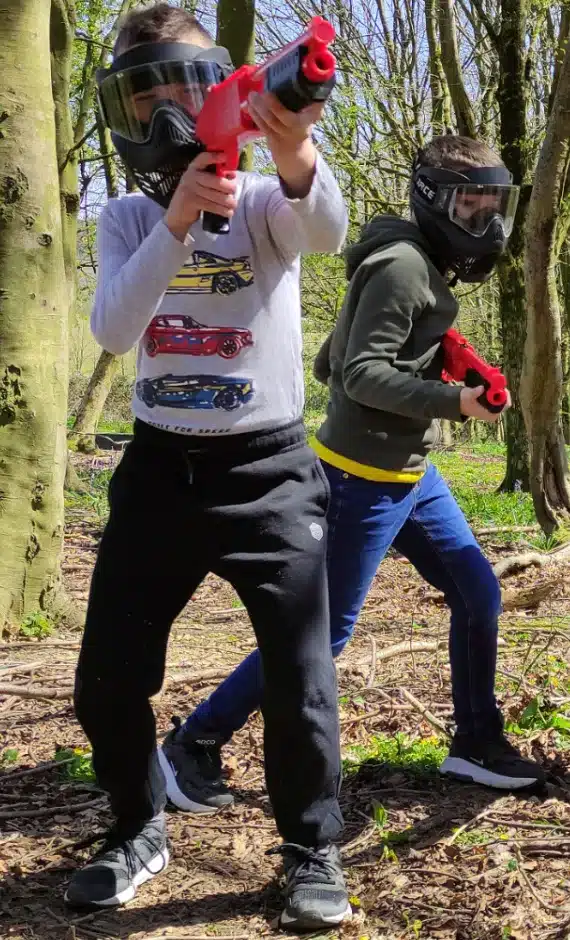 Children Aiming a Splatmaster Paintball Shotgun